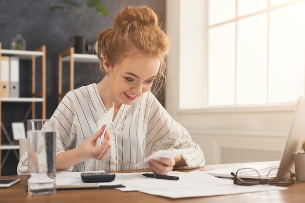 A person reviewing insurance policy documents with a calculator and pen, signifying the process of comparing rates and coverage to find better deals.