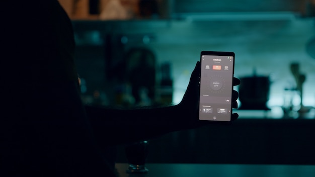 A close-up shot of a smartphone displaying a banking app interface. The screen shows an automated transfer setup, with details like the transfer amount, frequency, and destination account clearly visible. The background is blurred to focus on the app screen.