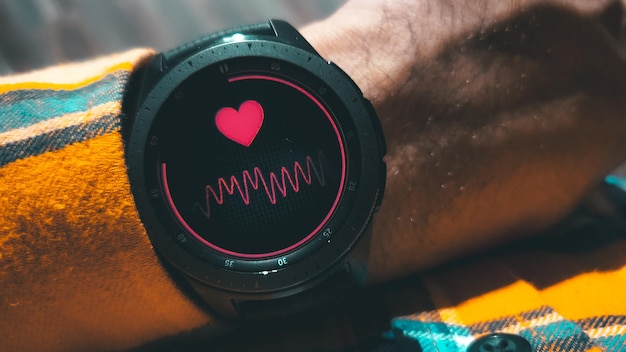 A detailed close-up of a smartwatch displaying heart rate and activity data, illustrating the continuous monitoring capabilities of remote patient monitoring devices. The screen should be clear and easy to read, highlighting the real-time data tracking.