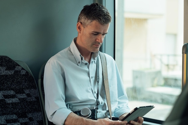 An IT professional reviewing a cybersecurity risk assessment report on a tablet, in a modern office environment.