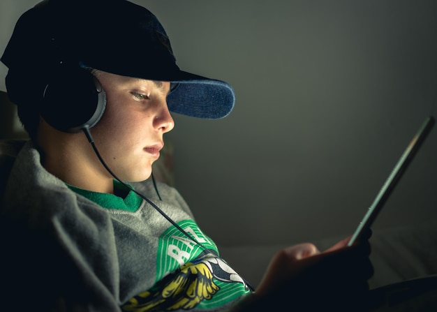 A close-up of a young student wearing headphones and interacting with an AI-powered learning application on a tablet. The screen displays a personalized learning path with interactive exercises and progress tracking. The student is smiling and appears to be fully engaged in the activity.