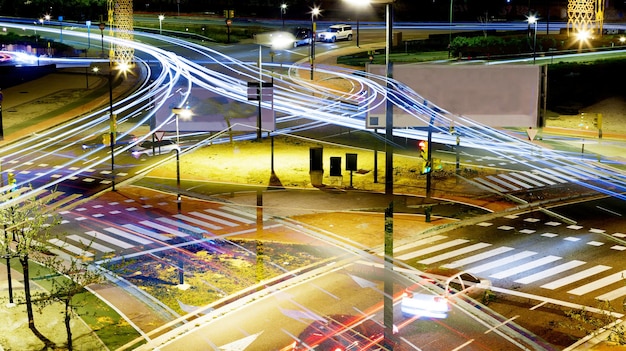 An intersection in a smart city with adaptive traffic signals dynamically adjusting to traffic flow. Autonomous electric buses are seen transporting passengers, and cyclists use dedicated bike lanes. The scene is clean, efficient, and environmentally friendly.
