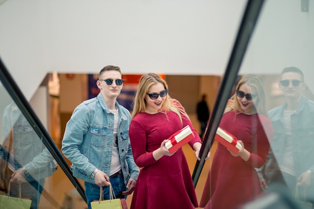 A group of shoppers excitedly browsing racks of clothing at a pop-up clothing sale. The atmosphere is lively, with bright lighting and colorful displays.