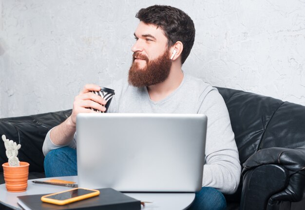 A person using a laptop, browsing an online discount website, with a focused and intent expression.