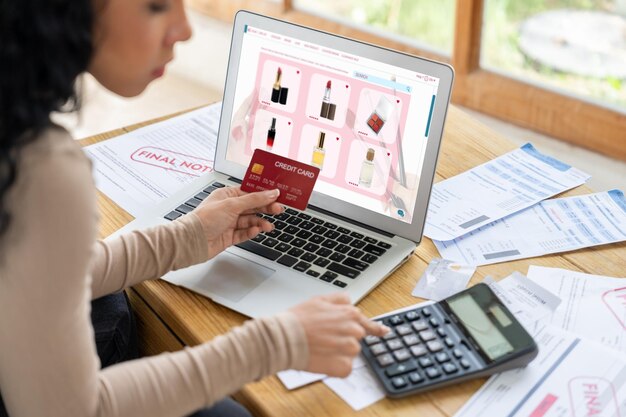 A person using a laptop, with a price comparison website displayed on the screen showing different prices for the same product.
