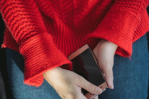 A close-up shot of a person's hands gently placing a smartphone face down on a wooden table. The background is blurred, suggesting a calm and quiet environment. The act symbolizes a conscious decision to disconnect from digital devices and embrace a break from technology. The warm lighting and natural wood texture evoke feelings of peace and relaxation.