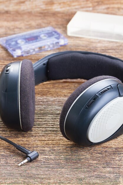 A close-up of a pair of noise-canceling headphones showcasing the microphone and electronic components involved in actively canceling out external sounds, with a diagram illustrating the sound wave inversion process.