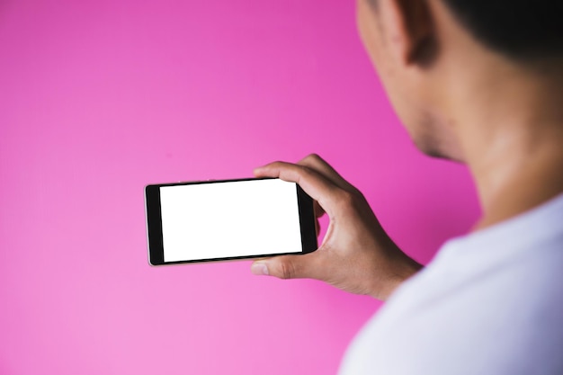 A close-up shot of a hand holding a smartphone, with the screen displaying an endless scroll of negative news headlines and social media posts. The background is blurred and dark, emphasizing the isolating and overwhelming nature of doomscrolling.