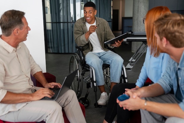 A diverse group of people with disabilities participating in a training session on how to use AI-powered assistive technology. The atmosphere should be positive and encouraging.