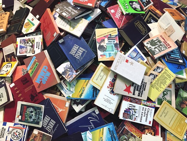 A collage of various student ID cards from different US universities scattered on a table. The image is bright and colorful, showcasing the diversity of student IDs and the importance of having one to access discounts.