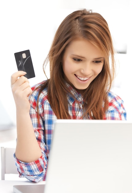 A close-up of a student ID card next to a laptop displaying a shopping website with a prominent student discount banner. The image highlights the ease of accessing online discounts with student verification.